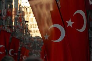 Turkish flags in focus on the street at sunset photo