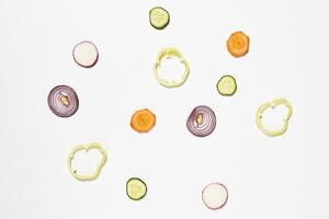 a white background with sliced vegetables photo