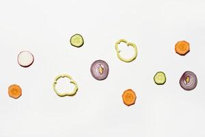 a white background with sliced vegetables photo