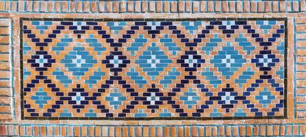 a tile mosaic with blue and orange designs photo