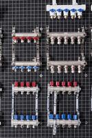 a group of valves and switches on a black board photo