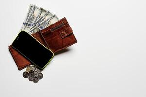 money and smartphone on white background photo