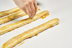 a person is making a pastry with a knife photo