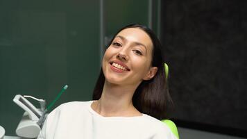 Beautiful woman smiles sitting in a dental chair video