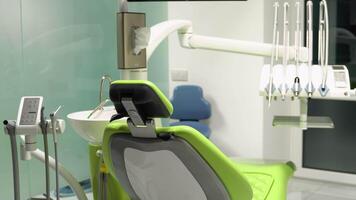 Dental chair with modern equipment placed in spacious office with cabinets and various tools in contemporary dentistry video