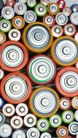 Old used batteries type AA, AAA, D rotate in a circle. Vertical video