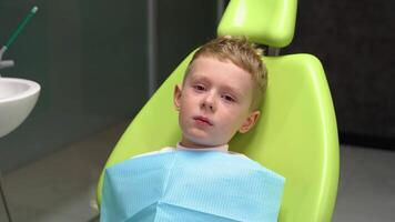 Sad little boy does not want to treat his teeth video