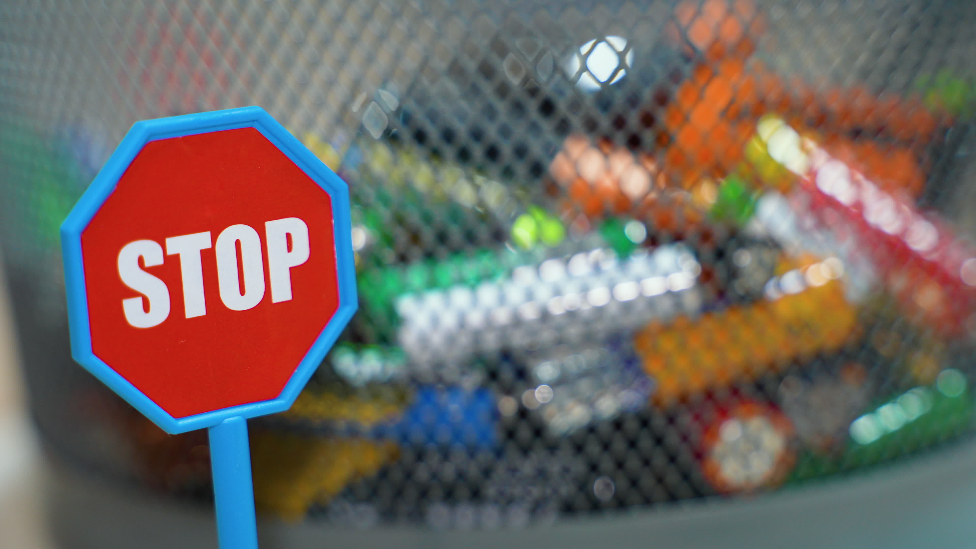 Different battery rotate in garbage bin. Stop pollution by batteries