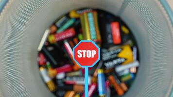 A person throws used batteries into office garbage bin. Stop pollution by batteries video