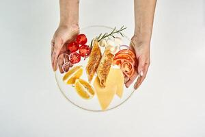 a person holding a plate with food on it photo