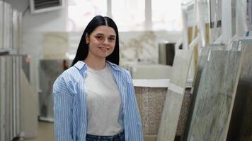 Portrait of woman in a hardware store. Woman choosing ceramic tiles video