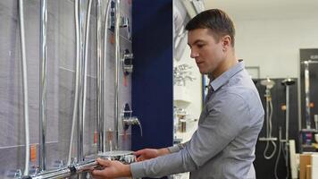 A man choosing a shower tap in a hardware store video