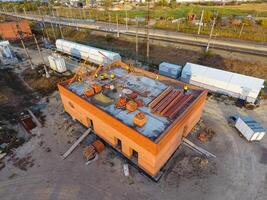 Russia, Krasnodar 2021. Construction of a brick building. Installation of the roof. Construction works. photo