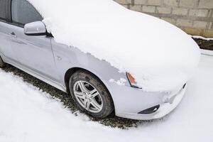 Russia, Novorossiysk 2021. Fall asleep wet snow car. Snowfall of wet snow. Snow lying on the car photo