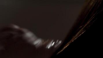 Close-up of a young man having his hair washed in a hairdressing salon. Frame. Man wash his head in a hairdresser. Barber washes customer hair slow motion close up video