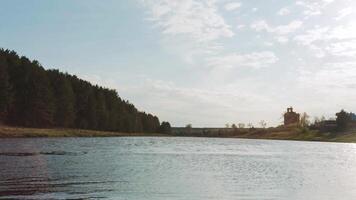 Sun over the river in the morning. Video. Green lawn near river in the forest. Sunset over water. Nature composition. by the river. Clear summer mountain lake with forest video