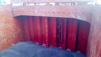 The cargo compartment of the ship, filled with coal. Loading of anthracite. Transportation of coal. photo