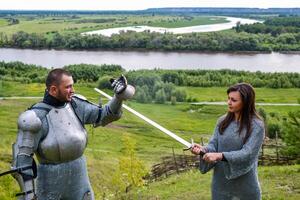 A lady in chain mail and a knight in armor photo