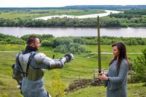 A lady in chain mail and a knight in armor photo