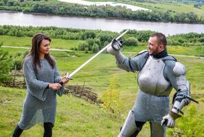 A lady in chain mail and a knight in armor photo