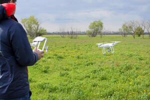 A man with a remote control in his hands. Flight control of the photo