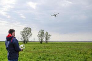 A man with a remote control in his hands. Flight control of the photo