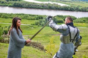 A lady in chain mail and a knight in armor photo