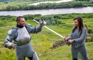 A lady in chain mail and a knight in armor photo