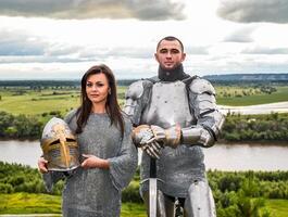 Knight with his lady in armor and chain mail. photo