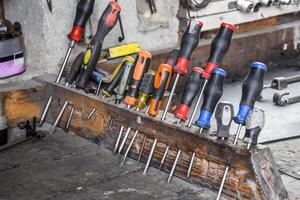 Screwdrivers and other tools in the car garage photo