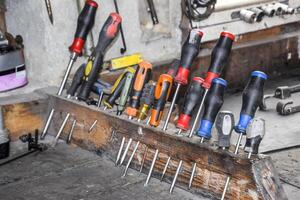 Screwdrivers and other tools in the car garage photo