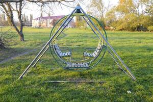 Swing on the playground. Children playground. Swings and a slide to slide photo