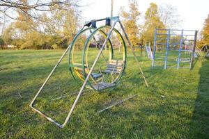 Swing on the playground. Children playground. Swings and a slide to slide photo