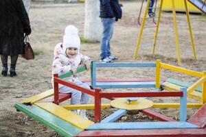 Dad plays with his daughter on the playground photo