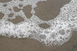a close up of a wave on the beach photo