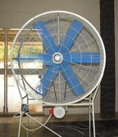 a large fan with blue blades on a floor photo
