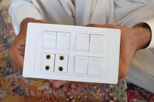 Electric switch board holding in hands photo