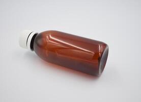 Glass amber bottle on white background photo