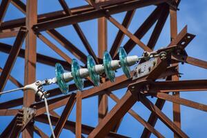 Glass prefabricated high voltage insulators on poles high-voltage power lines. Electrical industry photo