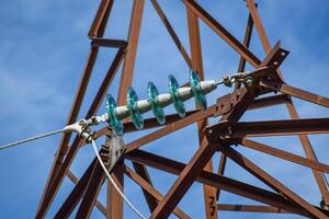 Glass prefabricated high voltage insulators on poles high-voltage power lines. Electrical industry photo