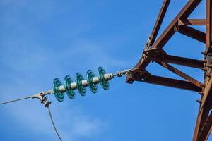 Glass prefabricated high voltage insulators on poles high-voltage power lines. Electrical industry photo