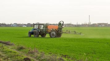 Tractor with a spray device for finely dispersed fertilizer. photo