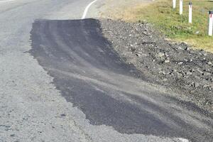 Repair of an asphalt road surfacing photo