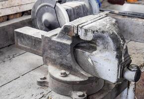 Vices on the bench. Ordinary vise. Equipment in the workshop photo