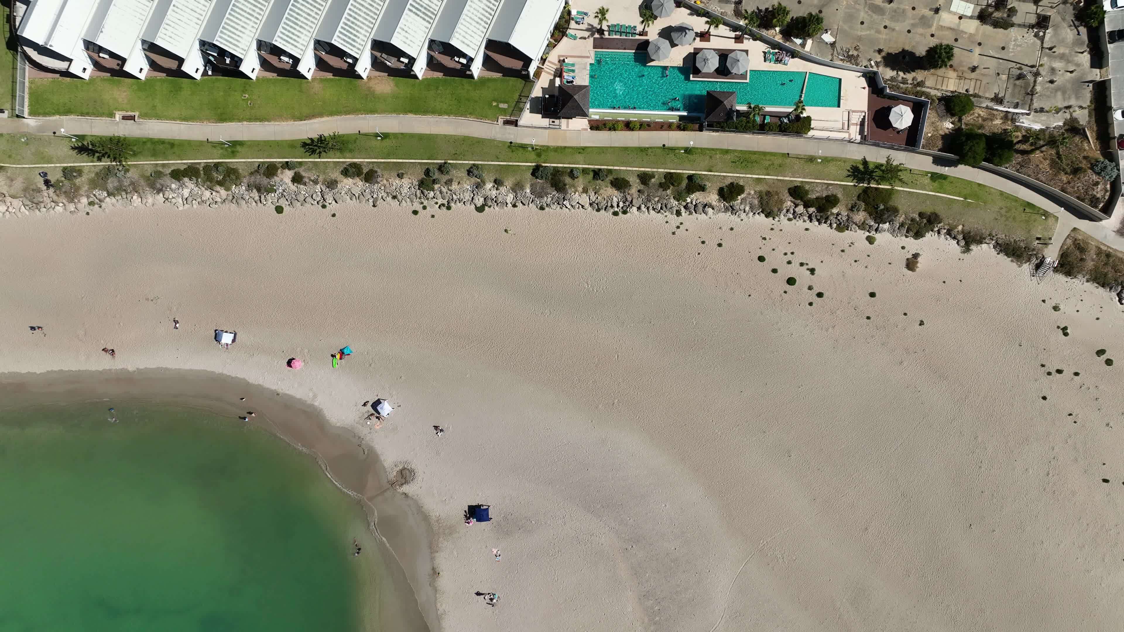 white sand beach hotel buildings mandurah australia 4k sunbathers