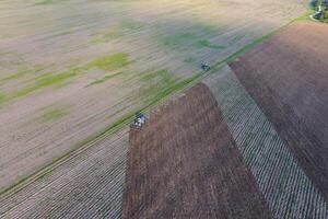 Top view of the tractor that plows the field. disking the soil. Soil cultivation after harvest photo