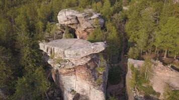 Forest and rocks in autumn aerial drone top view. Aerial view on Rocks, rock formation wth forest landscape. Climbing. A group of young climbers conquer the tops of rocks and mountains video