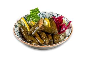 Yaprak sarma, Traditional Turkish cuisine delicacies. Delicious dolma or Samra stuffed grape leaves rice, white yogurt sauce. photo