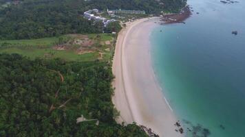 Aerial view beautiful beach and resort hotel on sea coast. Shot. Sandy beach on the sea coast with a rainforest. Scenery of the ocean shore with surf video