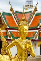 Golden statue of Kinnari inside Wat Phra Kaew Grand Palace Bangkok Thailand. photo